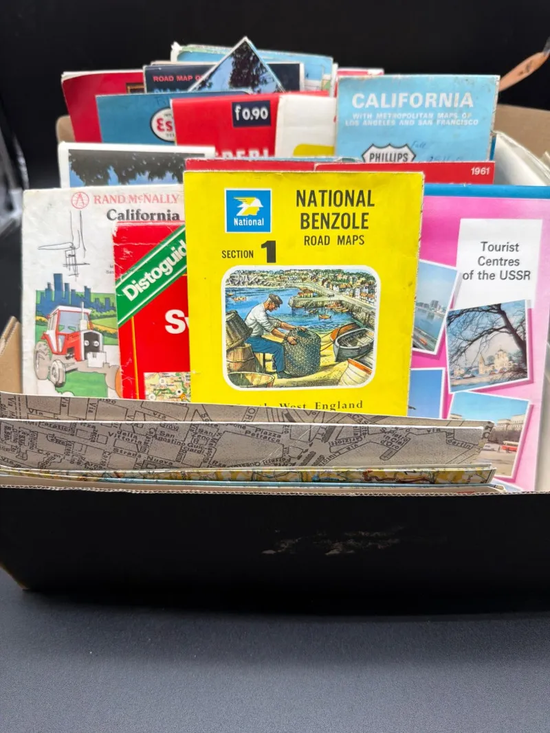 This item is a collection of vintage paper road maps and travel guides - Designer Decor and Other Treasures | Ocean Bid Auction