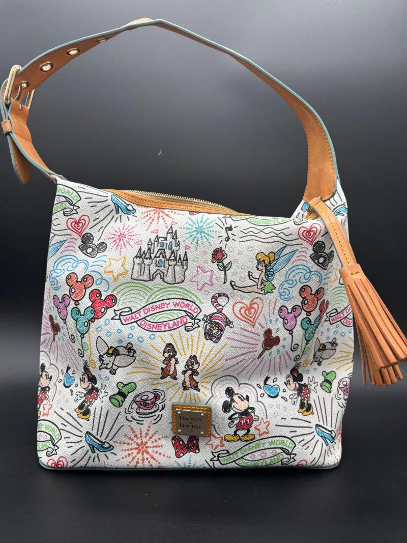 Dooney & Bourke Disney World Disneyland Print Shoulder Bag with Tassel - Mixed Treasures Auction | Ocean Bid Auction