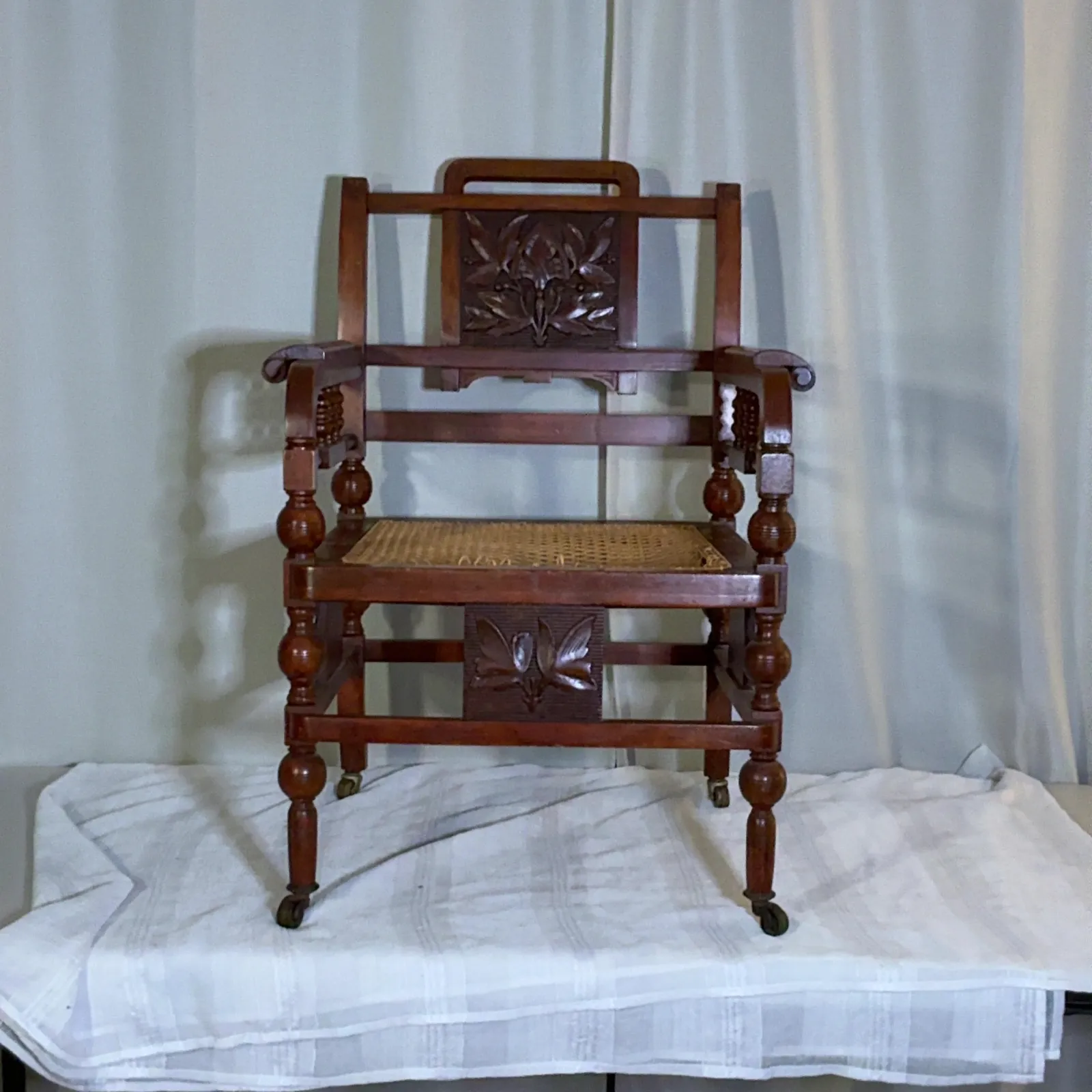 Carved Wood Cane Seat Armchair with Casters